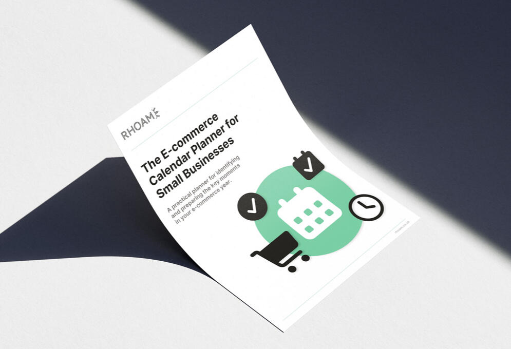 E-commerce Calendar Planner cover preview Mockup of the E-commerce Calendar Planner for Small Businesses cover placed on a desk surface, showing the Rhoam planner design with calendar, checklist, and shopping icons.